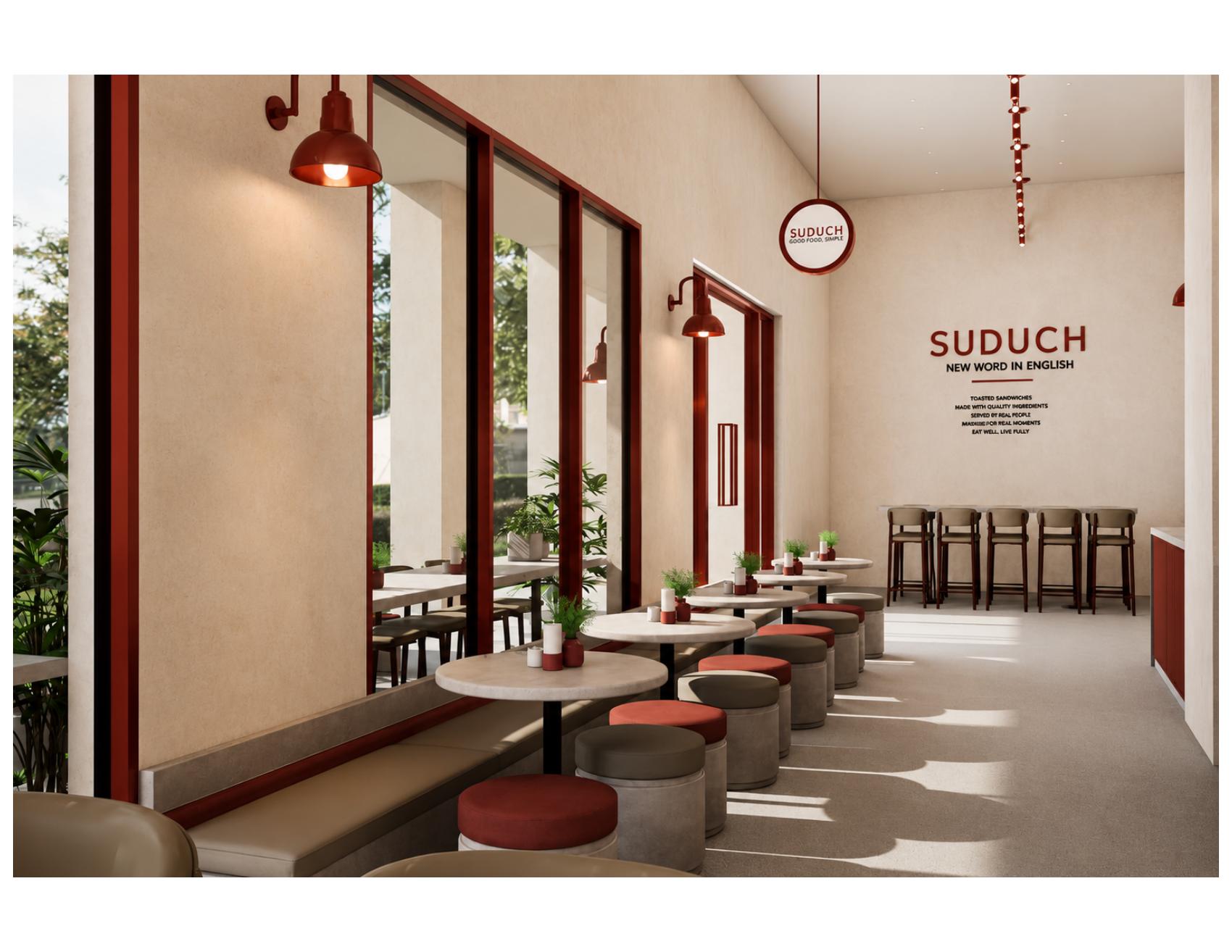 Suduch café design concept with warm cream walls, terracotta lighting and sunlit window seating